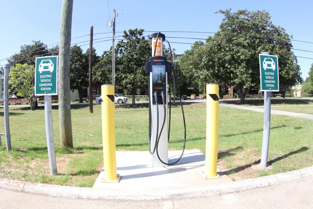 An electric charging station protected by bollards