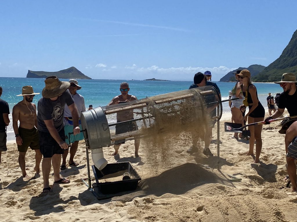 sifting machine on the beach.  Honolulu Post provided volunteers to support a microplastics beach cleanup to celebrate Earth Day in April.