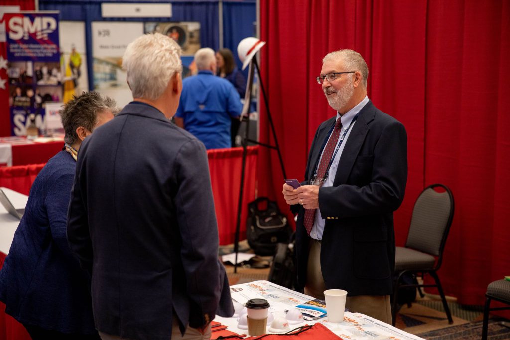 group talking over a table at a conference